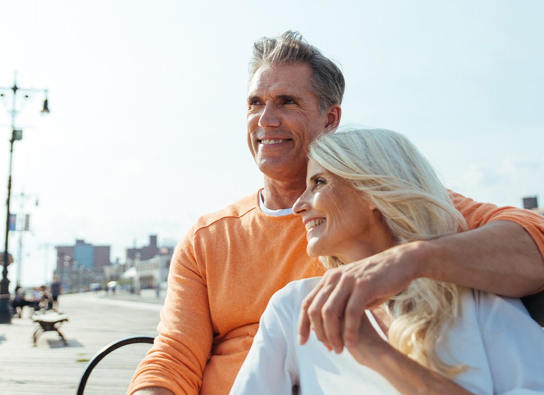 Medicare Plans - Happy Couple Outside on a Boardwalk Near the Beach on a Sunny Morning in the Summer