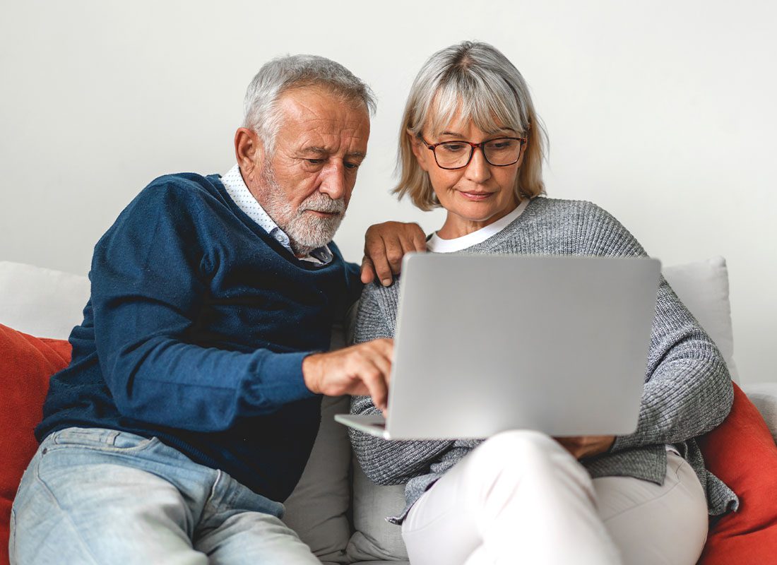 Read Our Reviews - Senior Couple Sitting on the Sofa While Looking at a Laptop