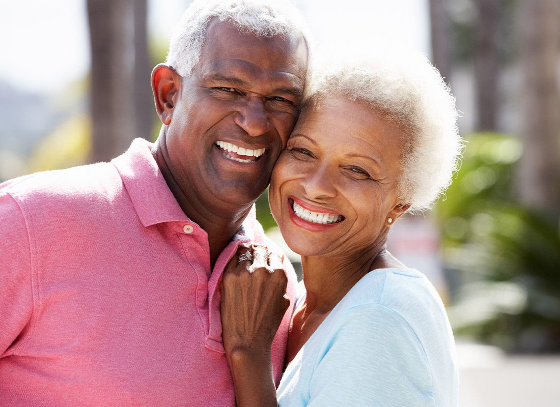 Medicare Advantage vs Medicare Supplement - Senior Couple Close-up While Embracing on a Sunny Day