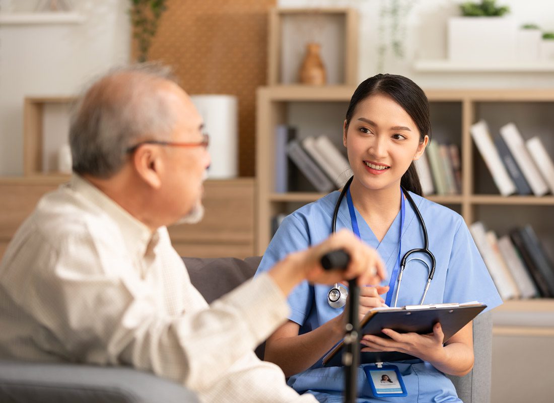 Medicare Supplement Plans - Senior Patient Talking To Caring Physician in a Nursing Home at a Medical Checkup Visit